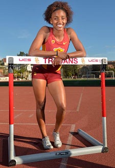 Image of USC freshman track star Dior Hall with high hurdle