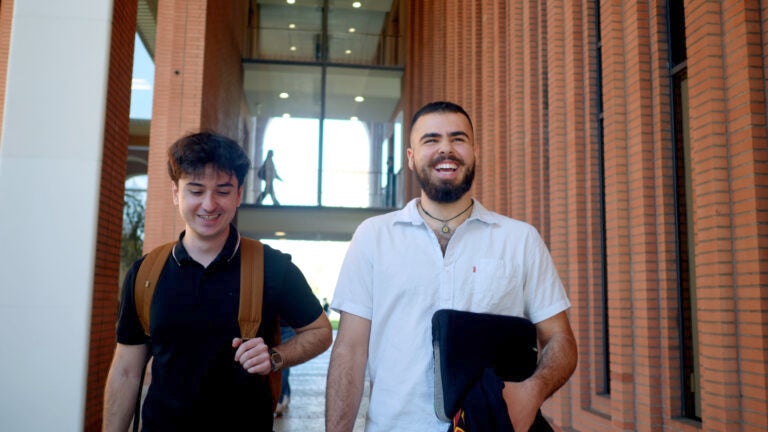 Students smiling and walking on the USC campus student resources