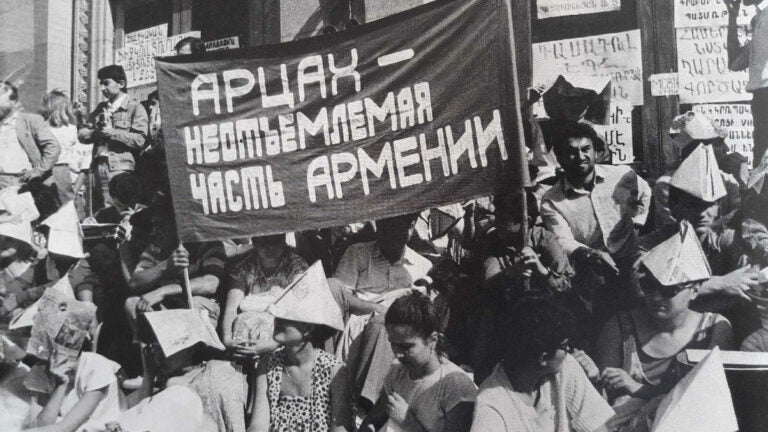 Protesters with a banner written in Russian saying that Artsakh is an essential part of Armenia Karabakh