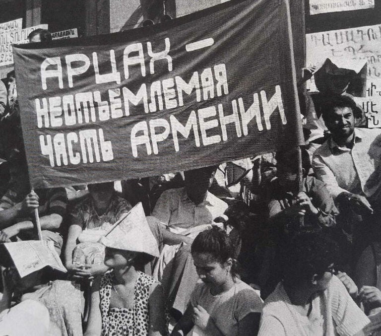 Protesters with a banner written in Russian saying that Artsakh is an essential part of Armenia Karabakh