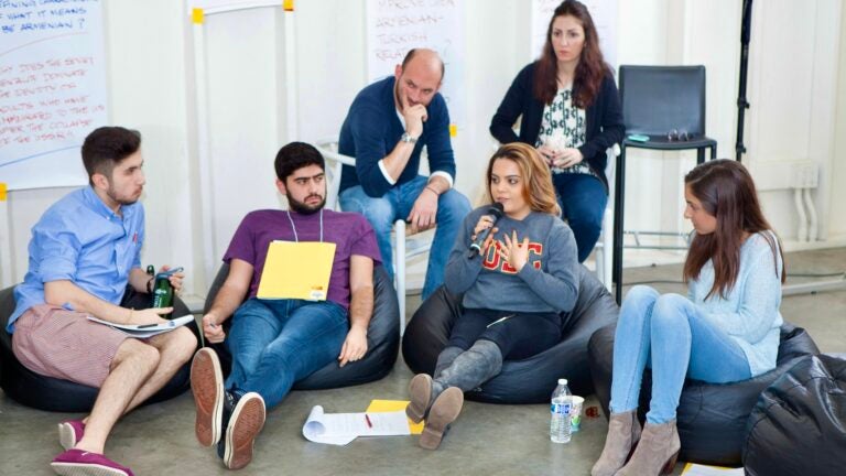 A group of participants seated and discussing topics at innovate Armenia