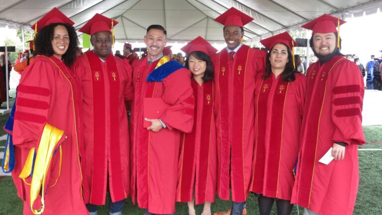 Seven American Studies and Ethicity graduate students at their graduation ceremony