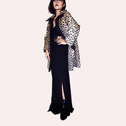 woman posing in leopard print coat and black jumpsuit