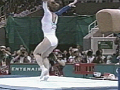 A gymnast landing after jumping off a vault