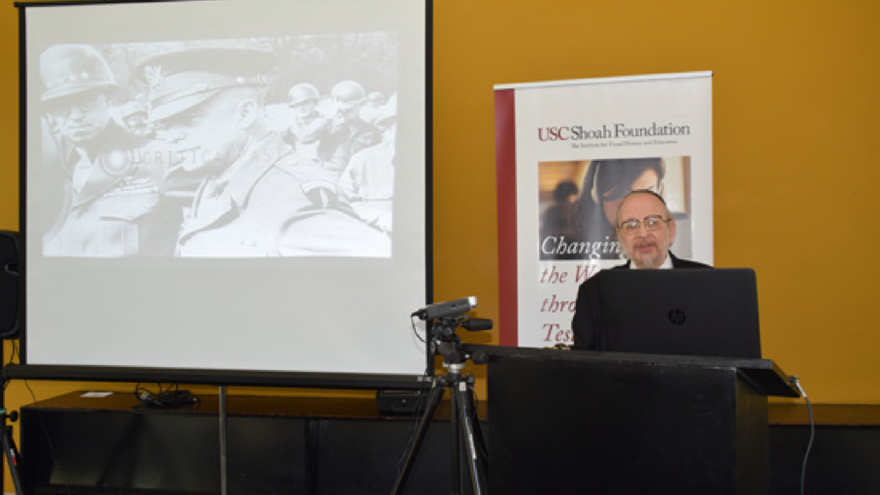 Harry Reicher presents at his lecture.