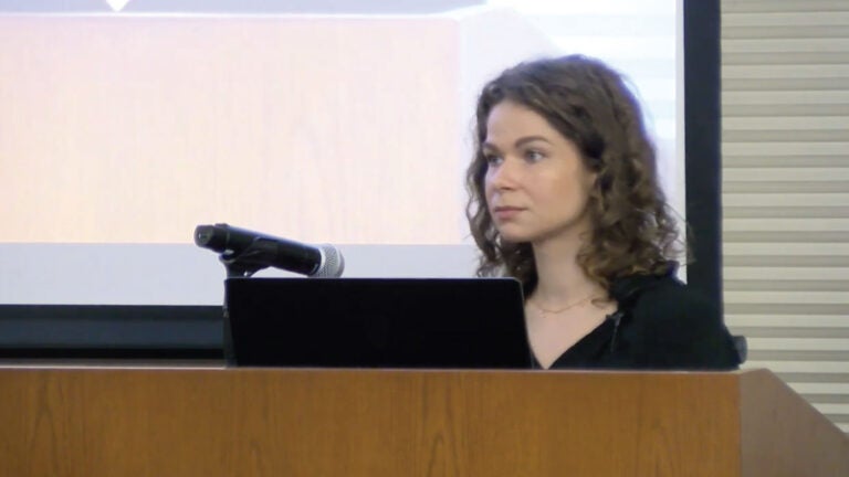 A still from Lilia Tomchuk's lecture video. It's zoomed in on her. She looks into the audience.