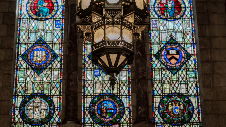 Picture of the Doheny Library stained glass windows and elaborate chandelier.