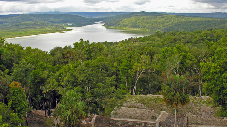 Scenic view of Mayan ruins at Laguna Yaxha in Guatemala.
