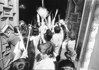 Black-and-white image of a group of people entering a cathedral