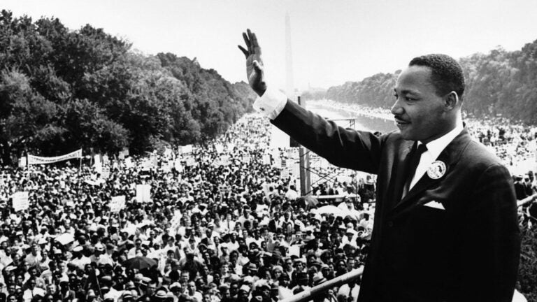 MLK overlooking the Washington Monument waves at crowd