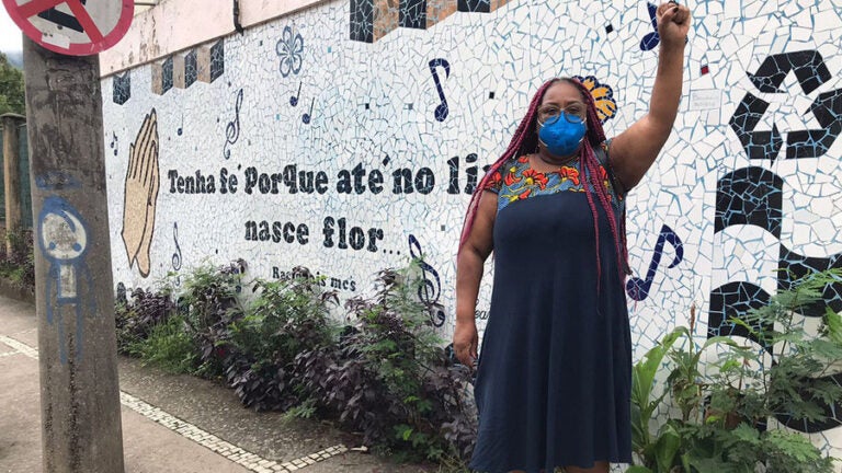 women stands outside with fist raised
