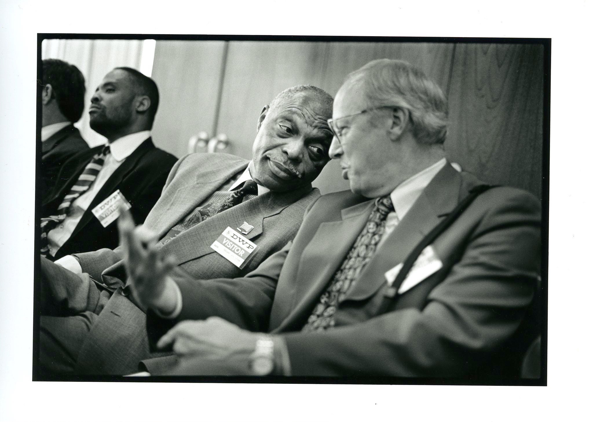 Rev. Dr. Cecil Murray leaning in to speak with Don Miller.