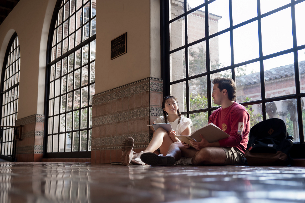 Two students studying together inside USC Mudd Hall