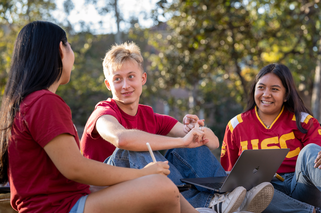 Three students talking together outside
