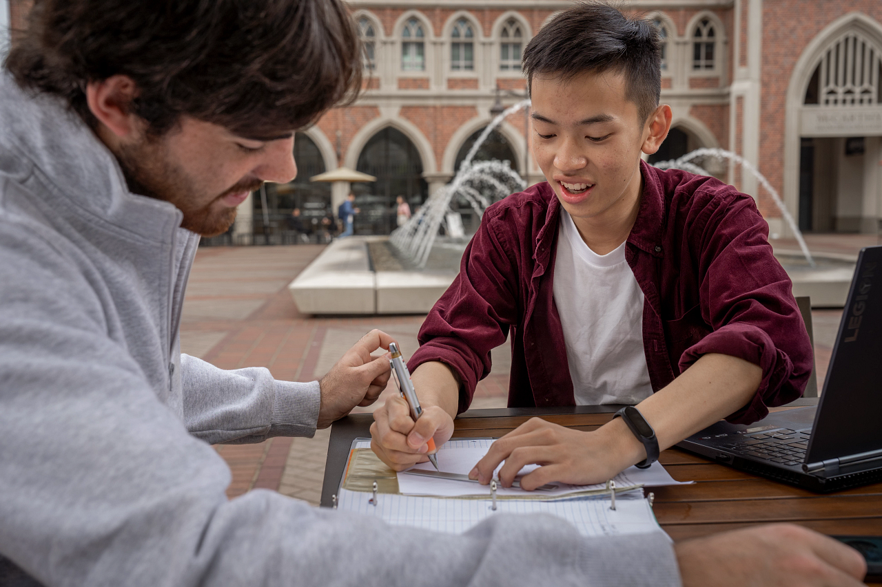 Two students working on homework together at the USC Village