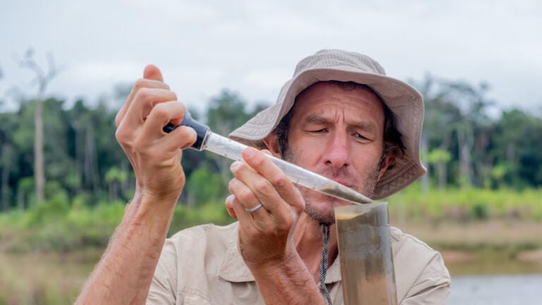 National Geographic Explorer Josh West monitors the sediment of a pond in the Madre de Dios region, an area impacted by artisanal gold mining activity.