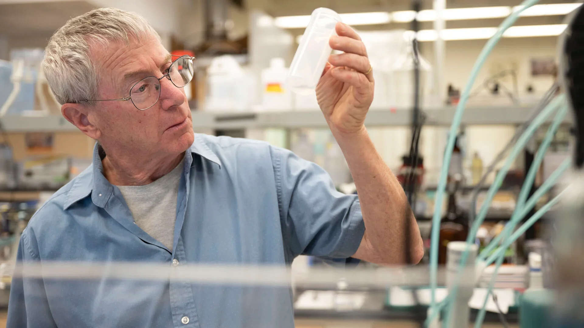 Will Berelson inspects a water sample collected off the coast of Huntington Beach. (USC Photo/Stephen Gee)