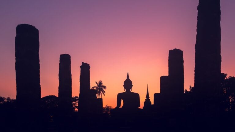 Silhouette of a Buddha state during the sunset.