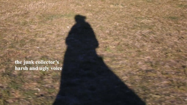 A person's shadow on the ground. Superimposed text reads 