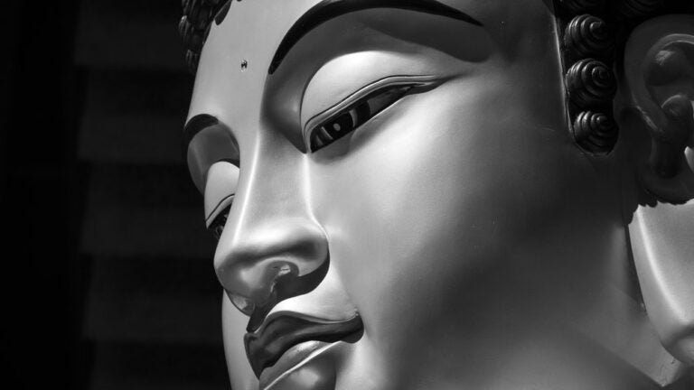 Black and white close-up of a Buddha statue
