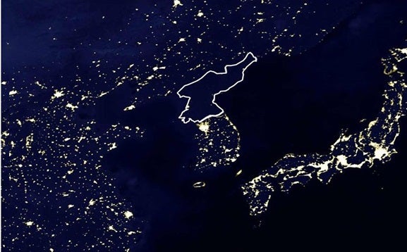 A map of East Asia centered on the Korean peninsula. The map shows the illumination of lights at night. All the other countries are illuminated in light except for North Korea.