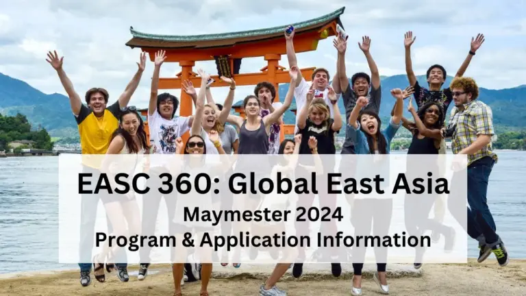 Multiple students jumping up for a group photo in front of a torii gate by a lake.