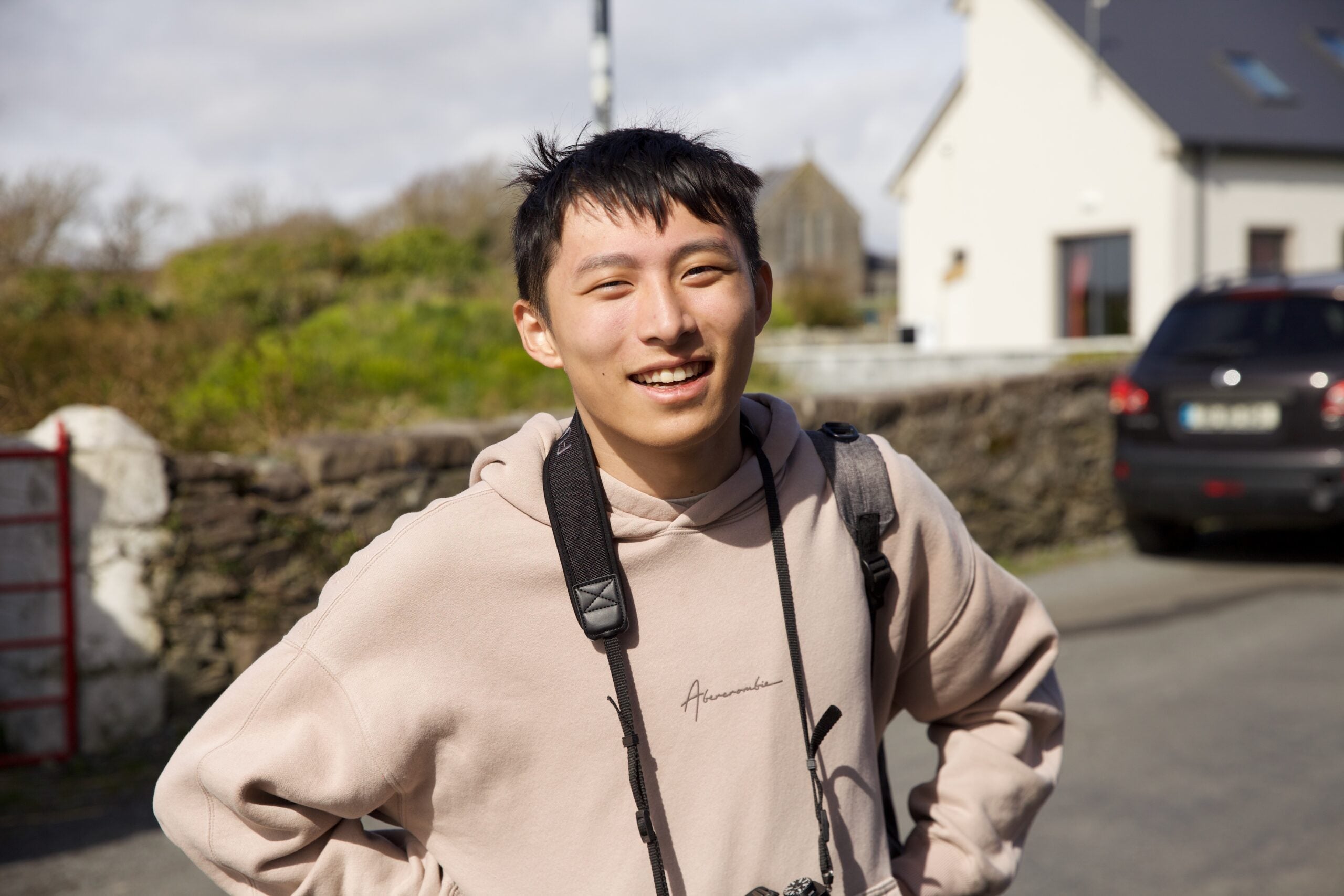 Headshot of Stanley Hong with a camera