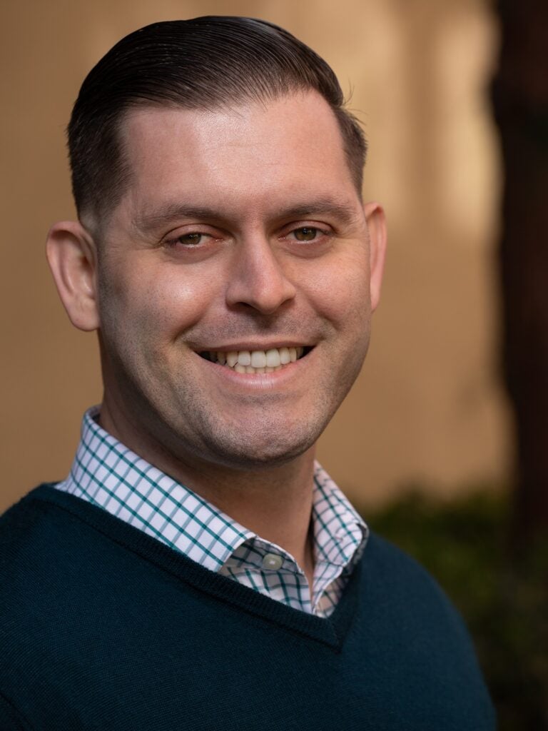 A headshot of an embedded therapist smiling.