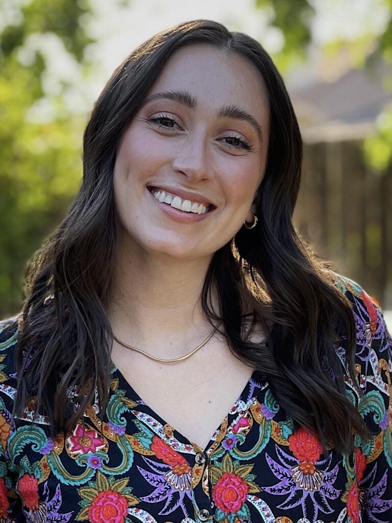A headshot of an embedded therapist smiling.