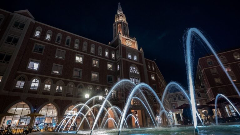 Fountain at USC late at night with a USC building in the background.