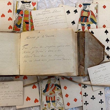 French 18th century manuscript game book surrounded by its playing cards