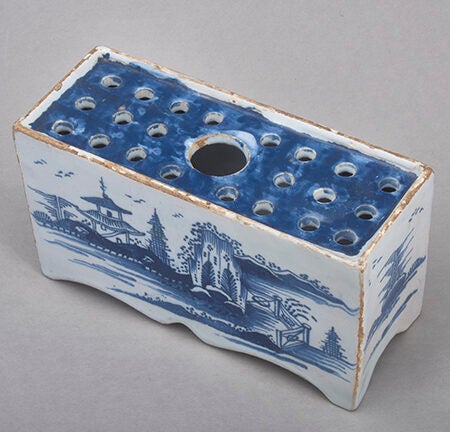 Rectangular ceramic brick with holes in top surface for inserting/holding flowers