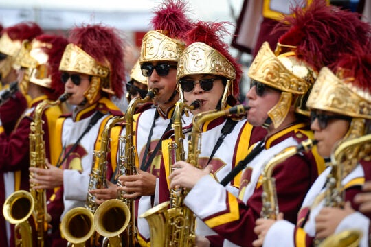 An up-close image of the USC Band's clarinet players. One player's head is turned looking at the camera.