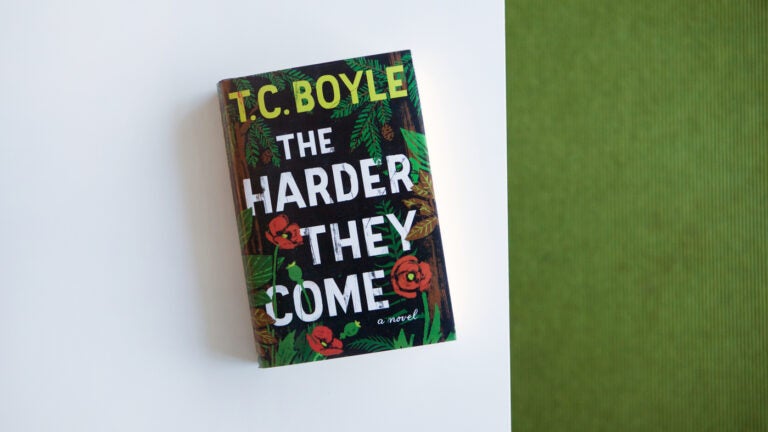 T.C. Boyle's novel lays face up. The novel cover consists of the author's name, book title, and illustrated flowers and greenery in the background.