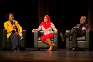 Speakers Gail Christopher, Najeeba Syed, and Manuel Pastor sitting on a stage and having a discussion at the USC PERE event, Turning the Page on Hate.