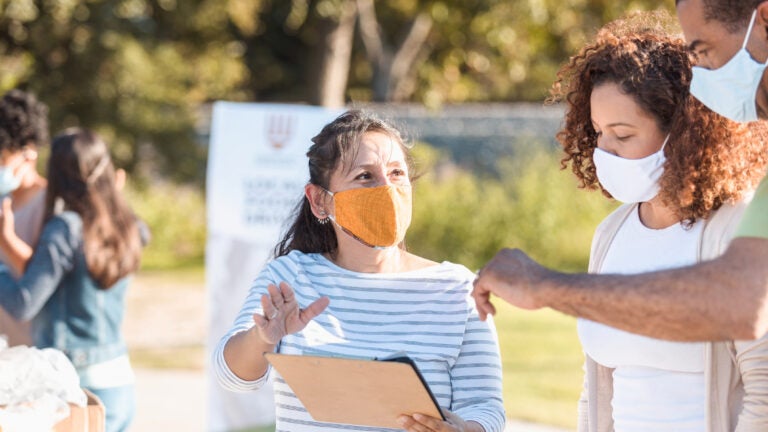 Adults discuss food drive organization during coronavirus outbreak