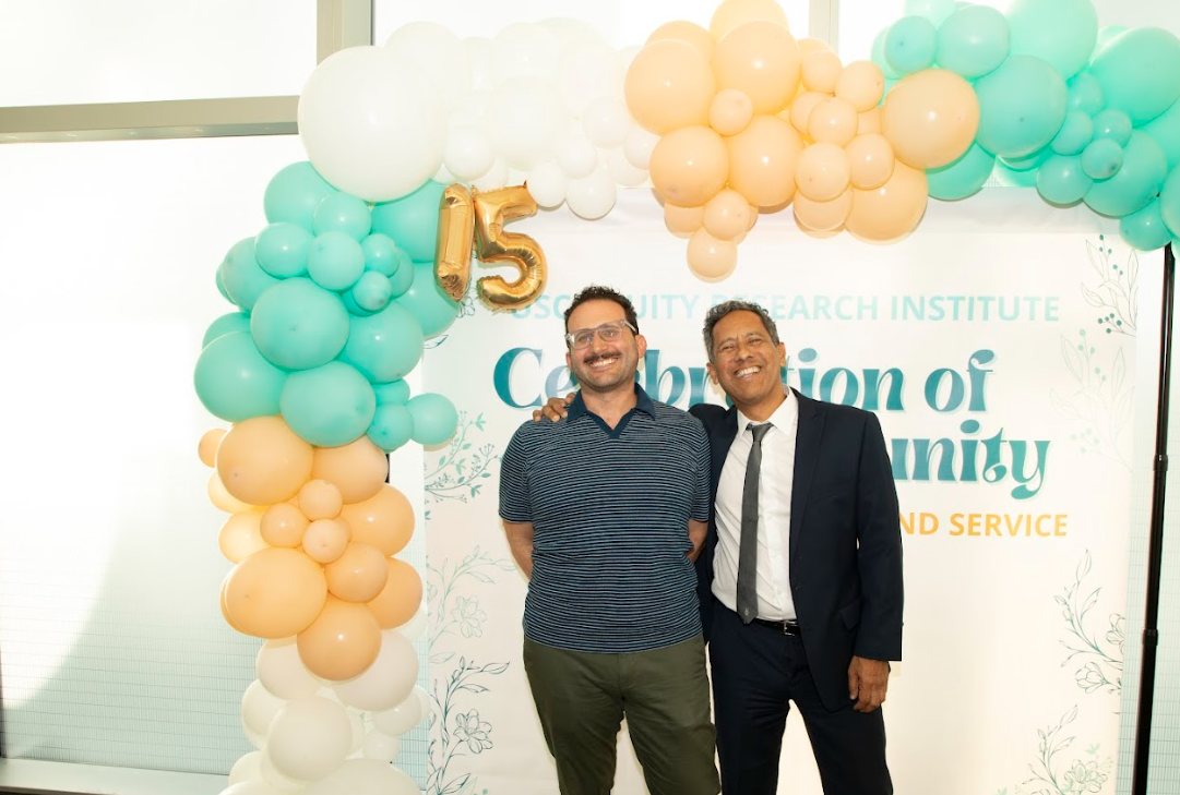 Two guests smiling at the ERI 15th Anniversary Party balloon display