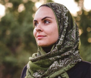 A woman wearing a hijab looking off to the side