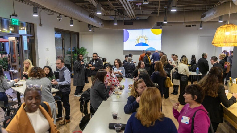 Room full of diverse attendees after event