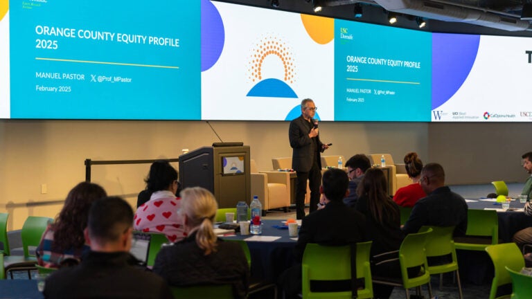 Wide view of Dr. Manuel Pastor presenting the Orange County Equity Profile 2025 report to a wide audience