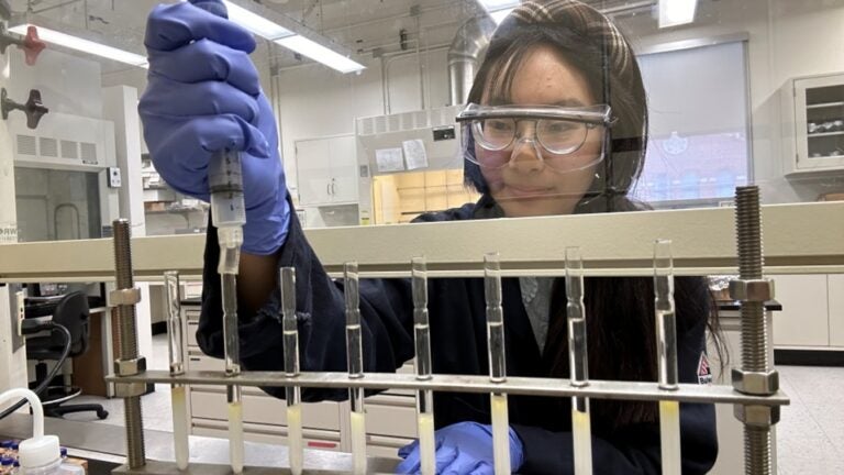 Iris Shen wearing gloves doing flash chromatography