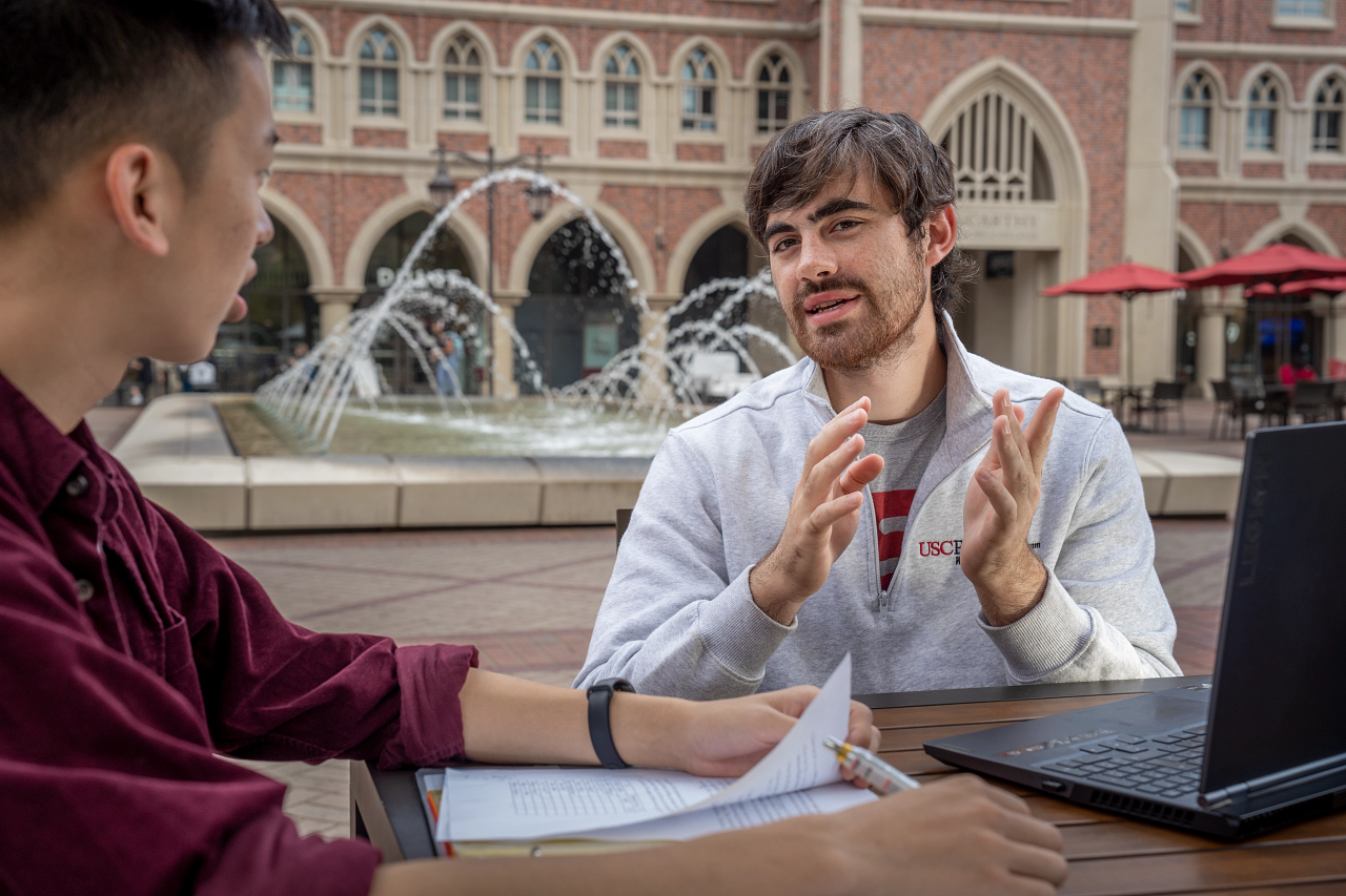 Students talking together at the USC village