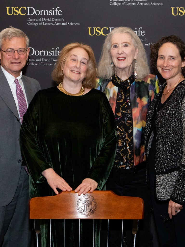 A group photo including USC Dornsife Dean Amber D. Miller, USC Provost Charles Zukoski, and Professor Anne Goldgar