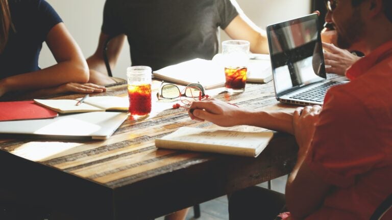 Image of a group of individuals sitting at a table