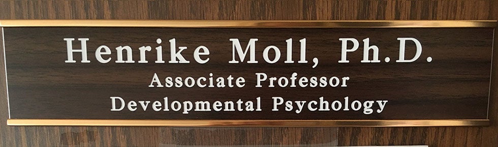 A name plate that reads: Henrike Moll, Ph.D Associate Professor, Departmental Psychology
