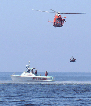 Helicopter and lifeguard boat assist with an issue in the ocean.
