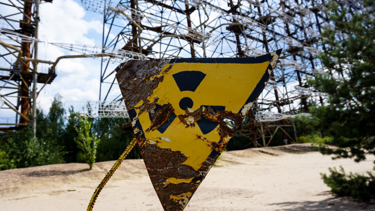 A rusting yellow sign warning of radiation