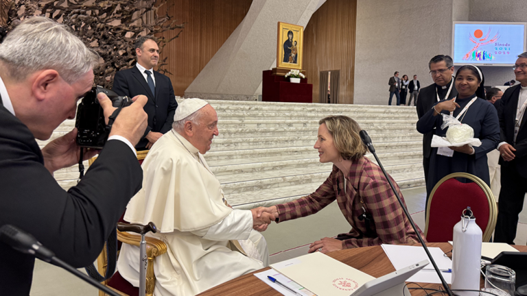 A photo of IACS Affiliated Scholar Tricia Bruce shaking hands with Pope Francis