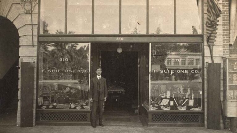 historic photo of shop front of f suite one co