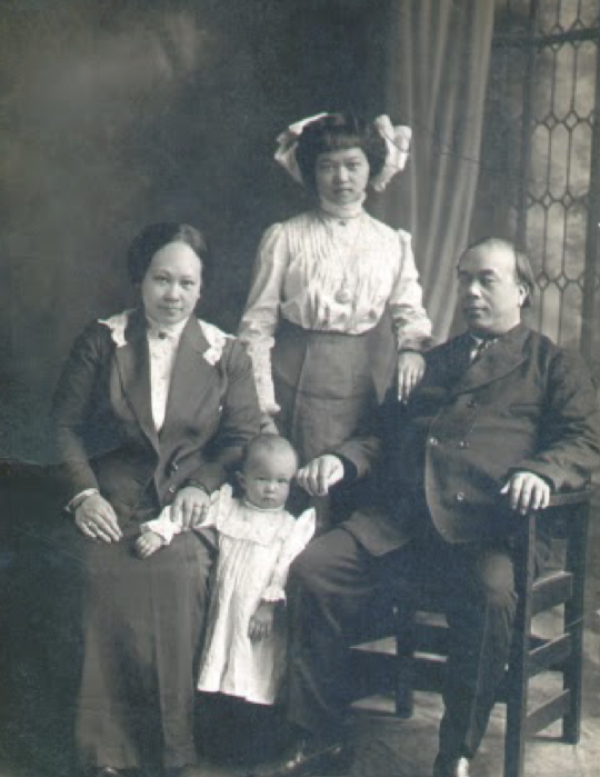 19th century black and white formal portrait of family of four members of the Soo Hoo Leung family.